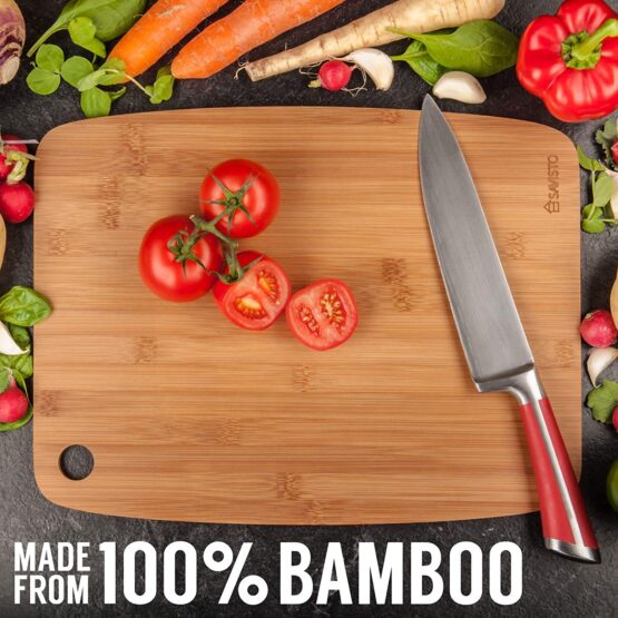 Chopping board with knife and vegetables around it.