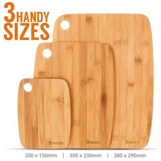 3 Wooden chopping boards standing up.