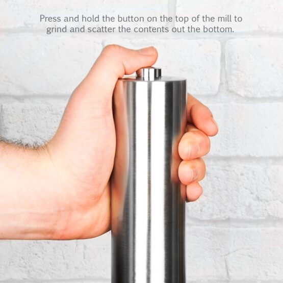 Hand holding a Peppermill ready to press automatic button
