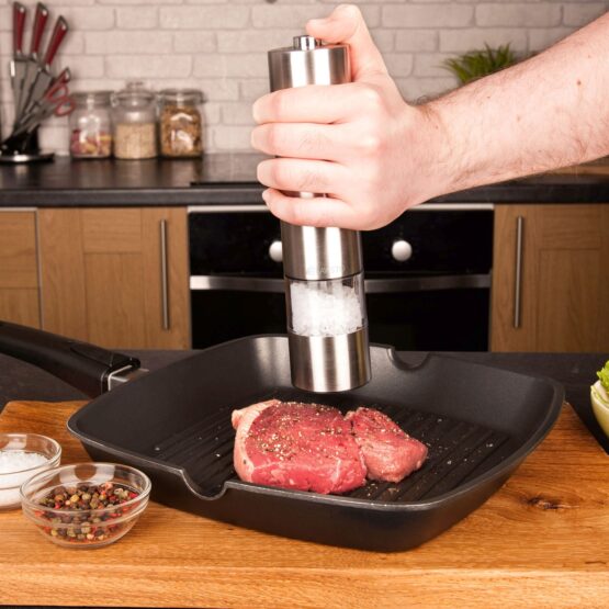 Silver Salt Mill over a steak on a pan