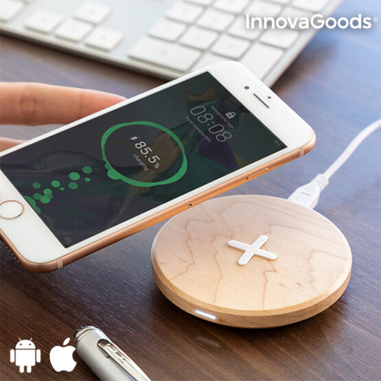 Hand holding Phone over wooden mobile wireless changer